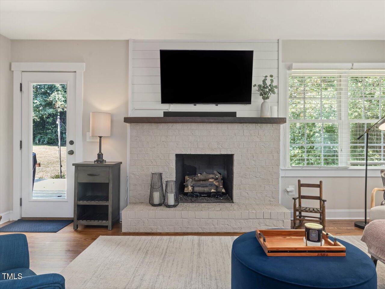1310 Carolina Pines Avenue Raleigh, NC 27603 - Photo 23 of 53 a living room with furniture a flat screen tv and a fireplace