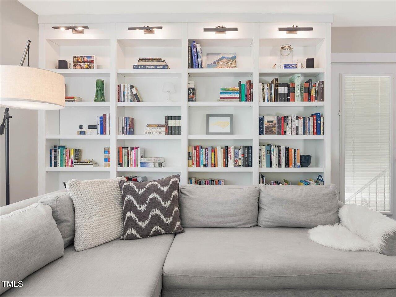 1310 Carolina Pines Avenue Raleigh, NC 27603 - Photo 24 of 53 a living room with furniture and a shelf with books