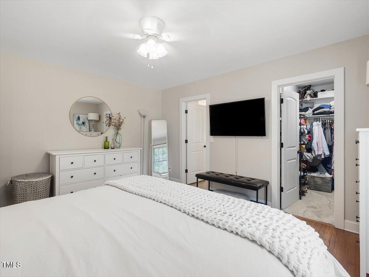 1310 Carolina Pines Avenue Raleigh, NC 27603 - Photo 32 of 53 a bedroom with a bed and a flat tv screen on dresser
