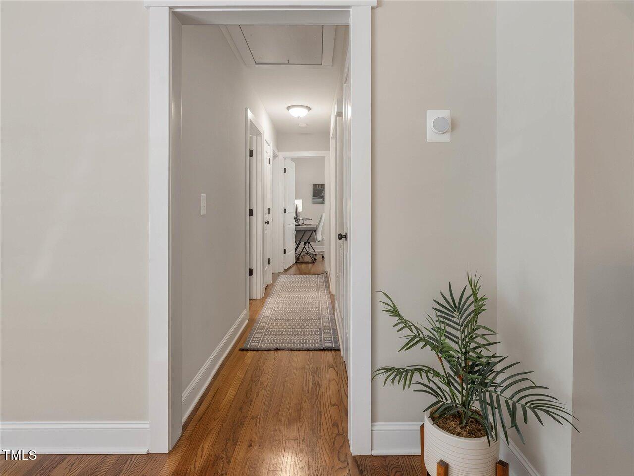1310 Carolina Pines Avenue Raleigh, NC 27603 - Photo 36 of 53 a view of a hallway with potted plants and wooden floor
