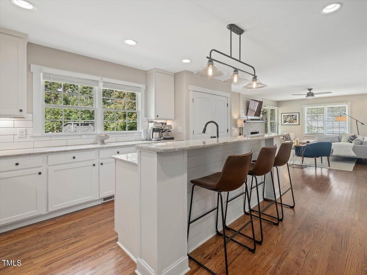 1310 Carolina Pines Avenue Raleigh, NC 27603 - Photo 5 of 53 a kitchen with a dining table chairs cabinets and wooden floor
