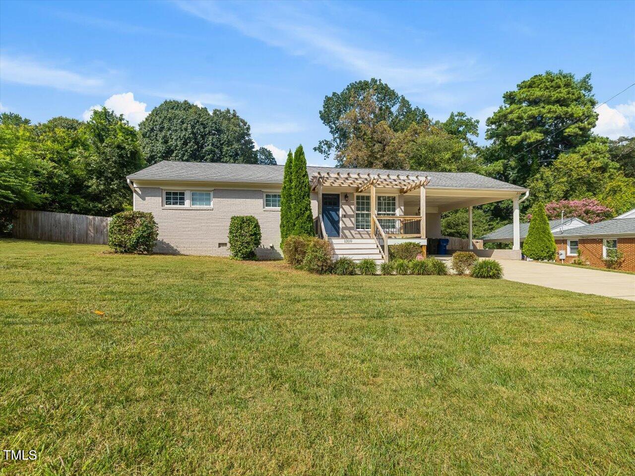 1310 Carolina Pines Avenue Raleigh, NC 27603 - Photo 8 of 53 a front view of a house with a yard