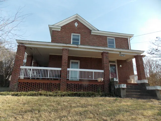 a front view of a house with iron fence