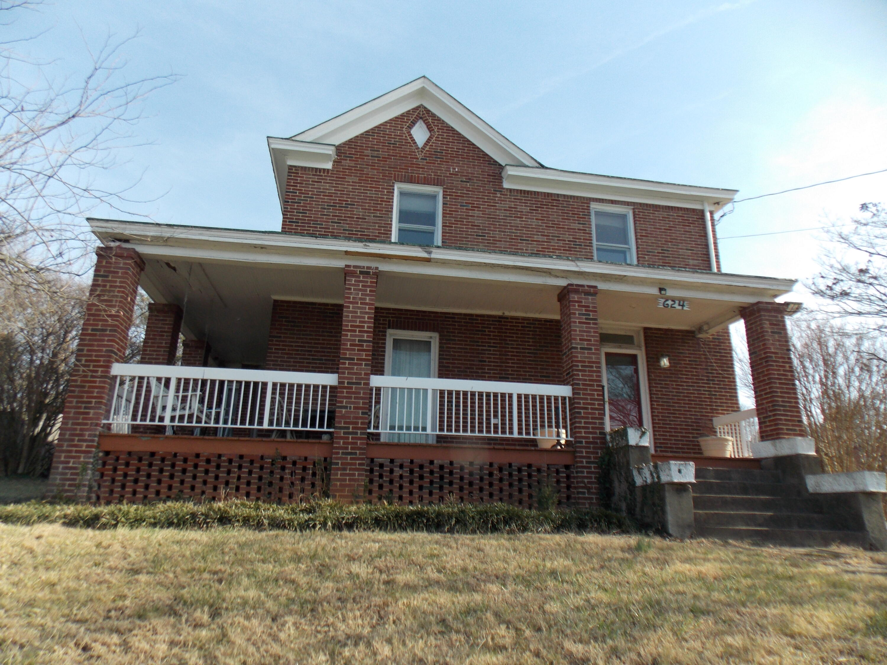 a front view of a house with iron fence