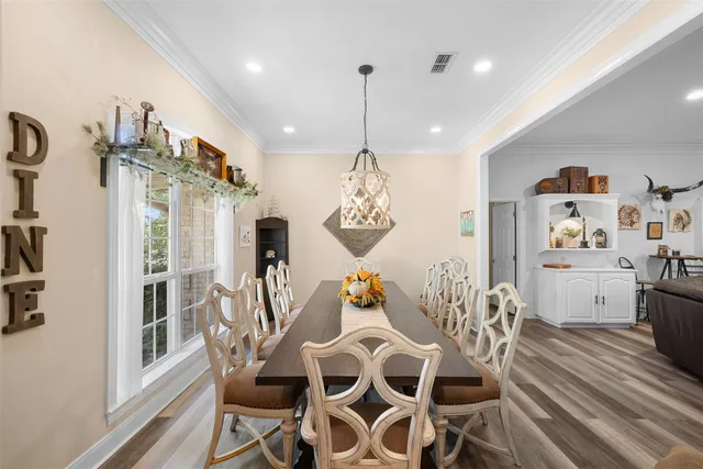 a view of a dining room with furniture wooden floor and a chandelier