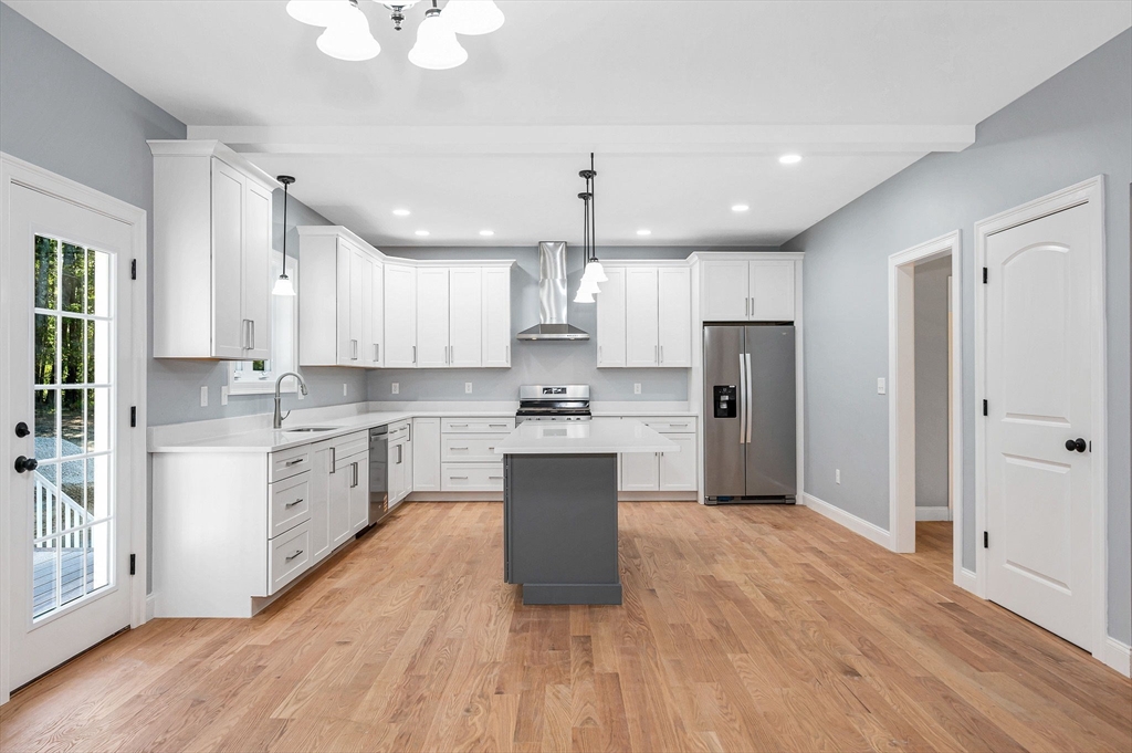 17 Norris Road Tyngsborough, MA 01879 - Photo 11 of 42 a kitchen with white cabinets and stainless steel appliances