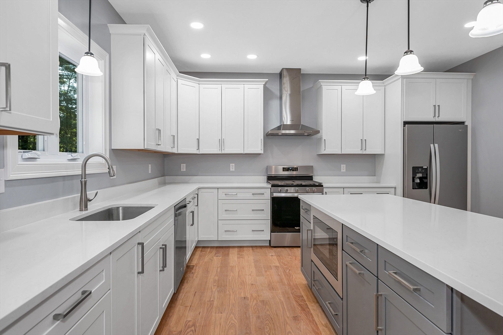 17 Norris Road Tyngsborough, MA 01879 - Photo 13 of 42 a kitchen with a sink a stove a refrigerator and cabinets