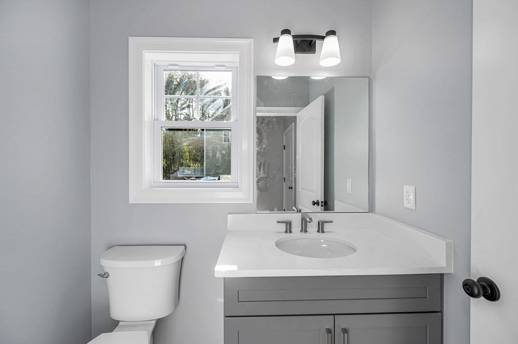 17 Norris Road Tyngsborough, MA 01879 - Photo 15 of 42 a bathroom with a toilet a sink and mirror