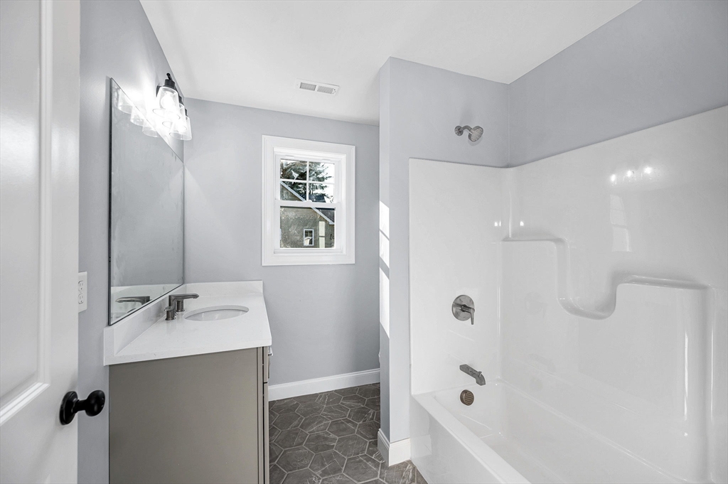 17 Norris Road Tyngsborough, MA 01879 - Photo 20 of 42 a bathroom with a bathtub shower sink and mirror