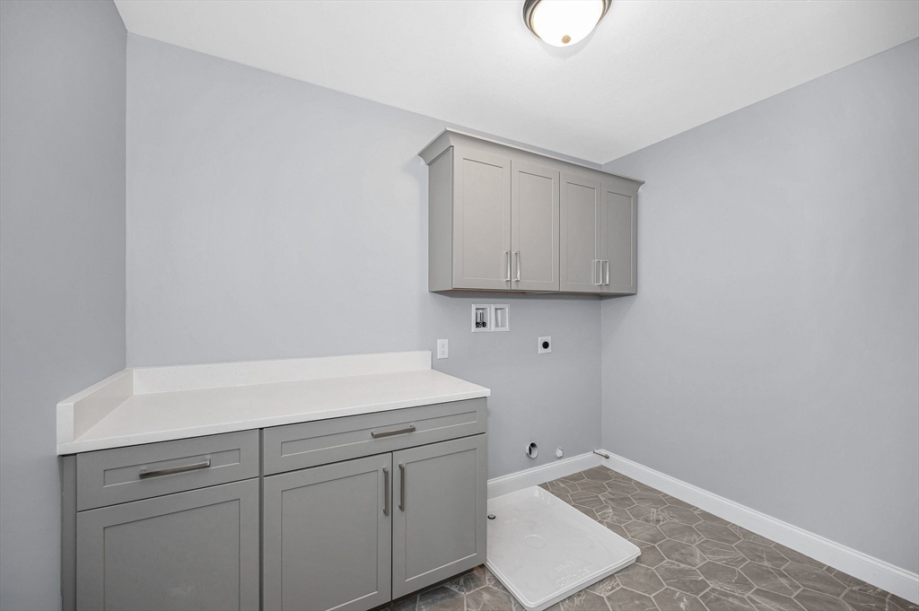 17 Norris Road Tyngsborough, MA 01879 - Photo 27 of 42 a utility room with cabinets