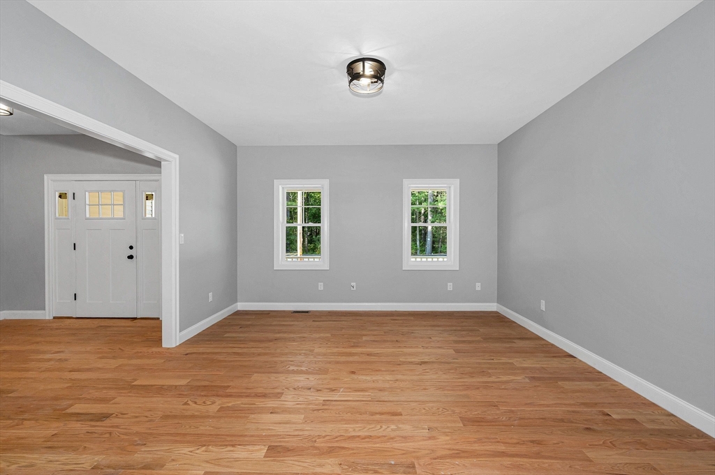 17 Norris Road Tyngsborough, MA 01879 - Photo 3 of 42 an empty room with wooden floor and windows