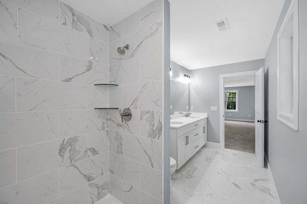 17 Norris Road Tyngsborough, MA 01879 - Photo 33 of 42 a bathroom with a double vanity sink a vanity a mirror and shower