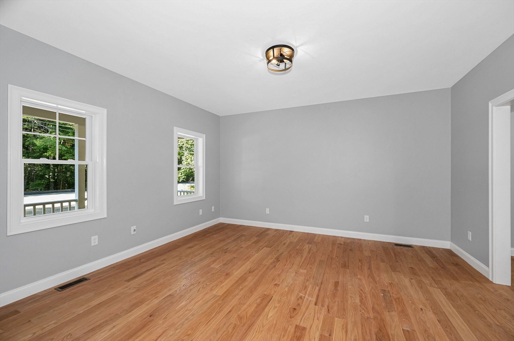 17 Norris Road Tyngsborough, MA 01879 - Photo 5 of 42 a view of an empty room with wooden floor and a window