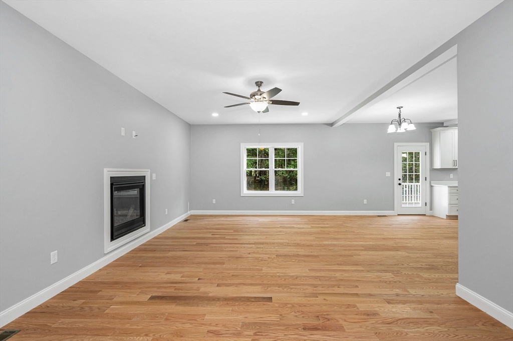 17 Norris Road Tyngsborough, MA 01879 - Photo 6 of 42 a view of an empty room with a window and a kitchen