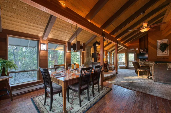a dining room with furniture and wooden floor