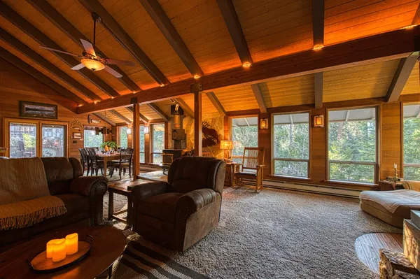 a living room with furniture and a floor to ceiling window