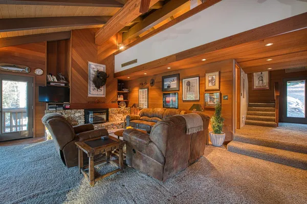 a living room with furniture a fireplace and a flat screen tv