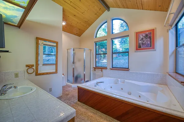 a bathroom with a bathtub and next to a window