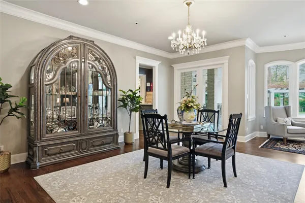 a view of a dining room with furniture and chandelier