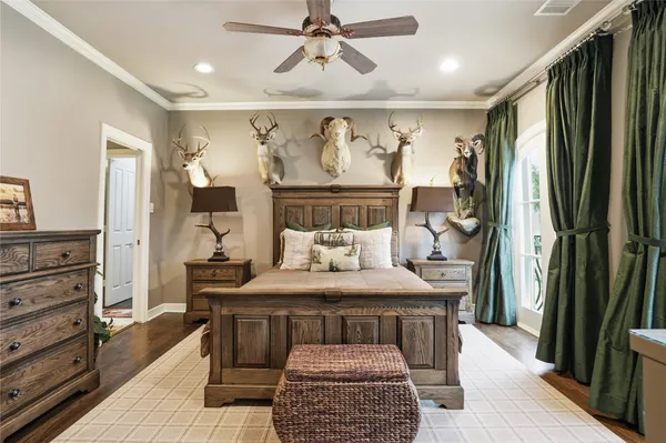 a bedroom with a bed and a dresser with mirror