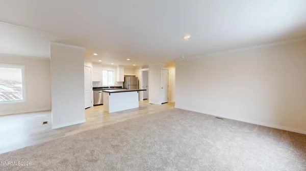 a kitchen with stainless steel appliances kitchen island granite countertop a stove top oven a sink and a refrigerator