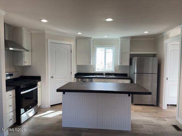 4890 Brayton Road Winnemucca, NV 89445 - Photo 8 of 20 a kitchen with kitchen island stainless steel appliances a sink stove and refrigerator