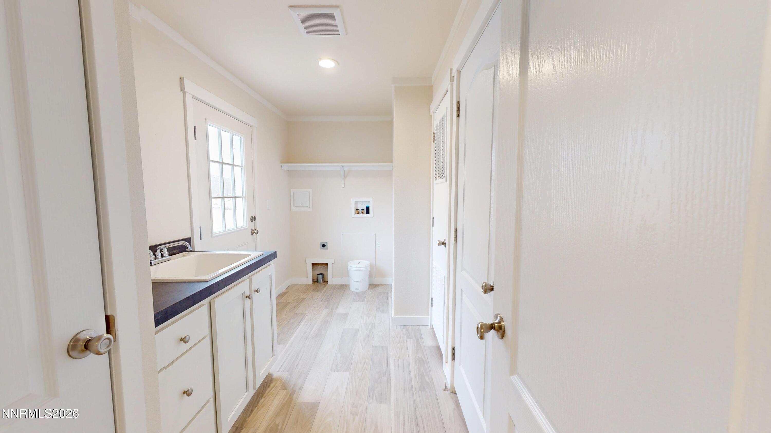 4890 Brayton Road Winnemucca, NV 89445 - Photo 9 of 20 a bathroom with a sink a toilet a window and a mirror