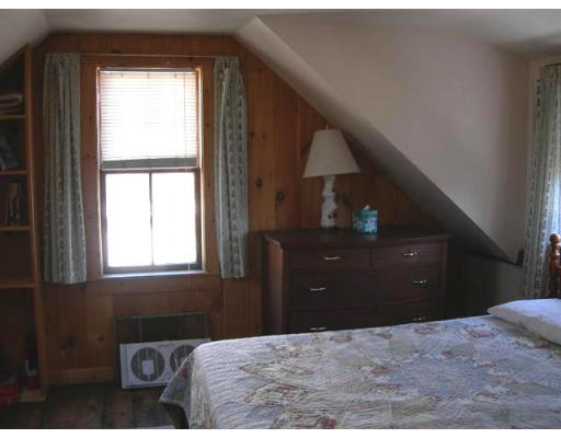7 N Road Rockport, MA 01966 - Photo 6 of 7 a living room with a bed and a dresser