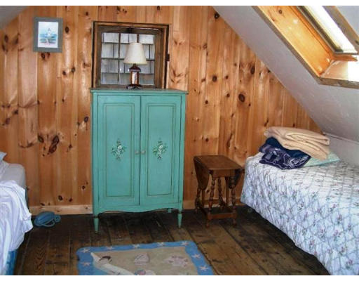 7 N Road Rockport, MA 01966 - Photo 7 of 7 a bedroom with a bed and a mirror
