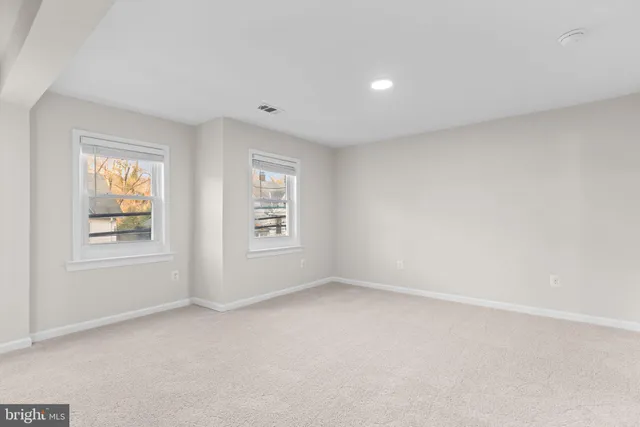 a picture of a bench in front of a wall