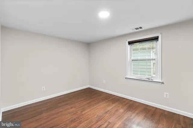 a bathroom with a granite countertop sink a mirror and a shower
