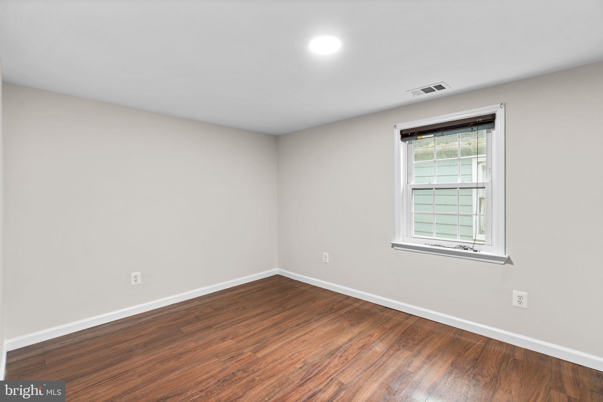 8483 Frederick Road Ellicott City, MD 21043 - Photo 25 of 44 wooden floor in an empty room with a window