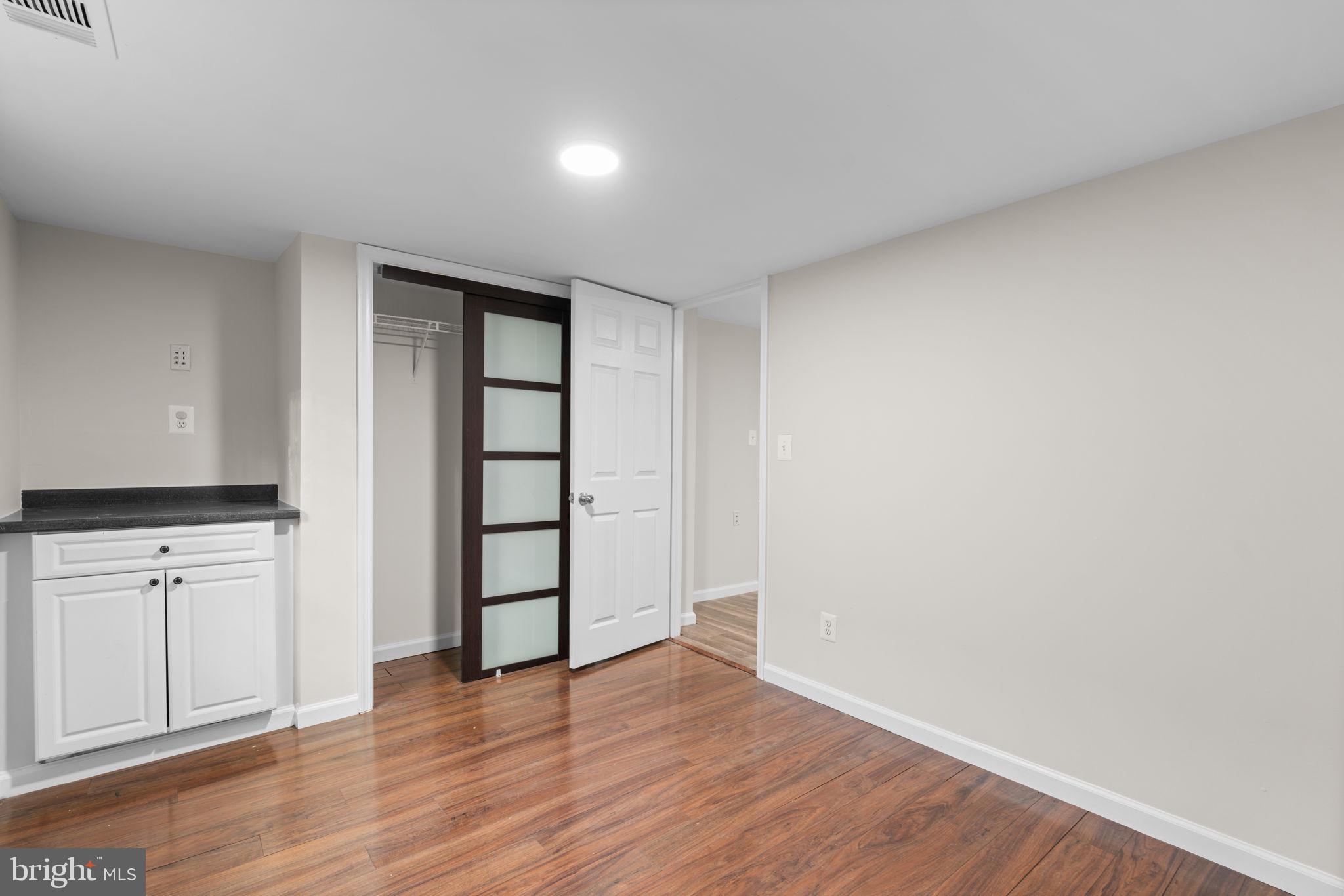 8483 Frederick Road Ellicott City, MD 21043 - Photo 26 of 44 a view of an empty room with window and wooden floor
