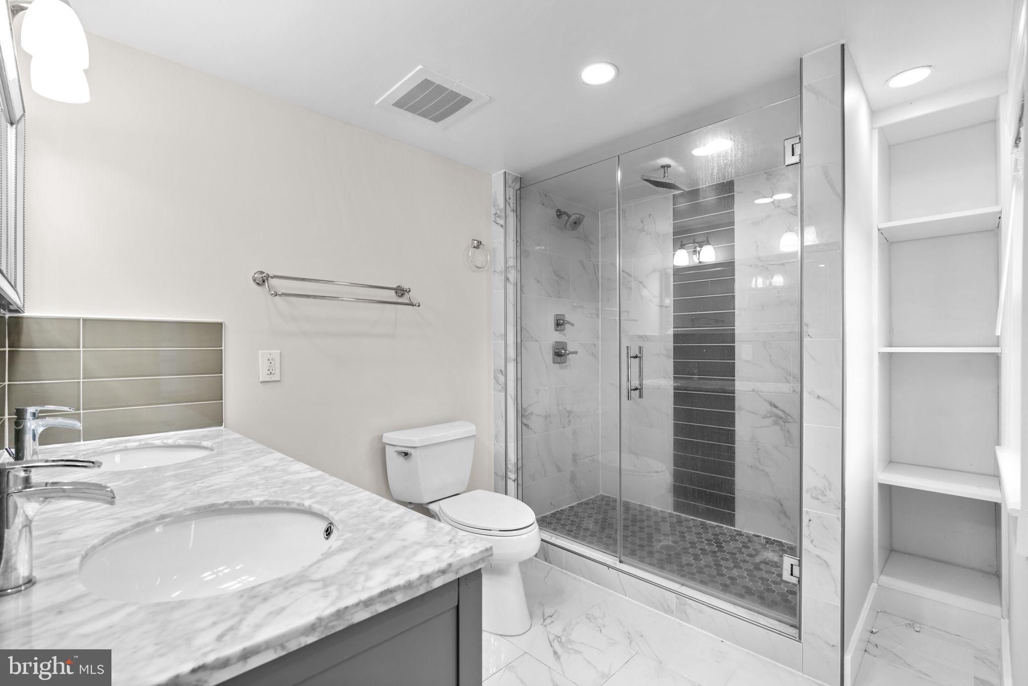 8483 Frederick Road Ellicott City, MD 21043 - Photo 3 of 44 a bathroom with a granite countertop sink mirror and shower