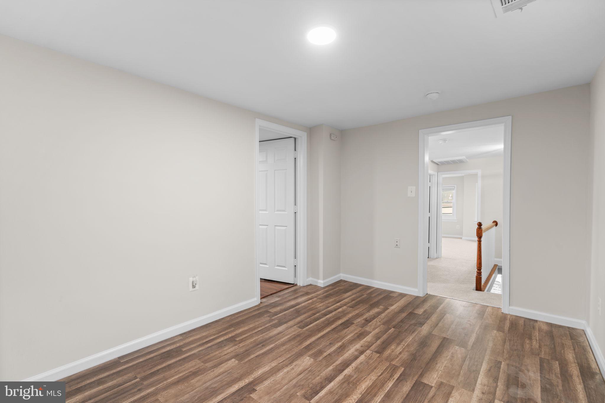 8483 Frederick Road Ellicott City, MD 21043 - Photo 30 of 44 a view of a room with wooden floor and bathroom