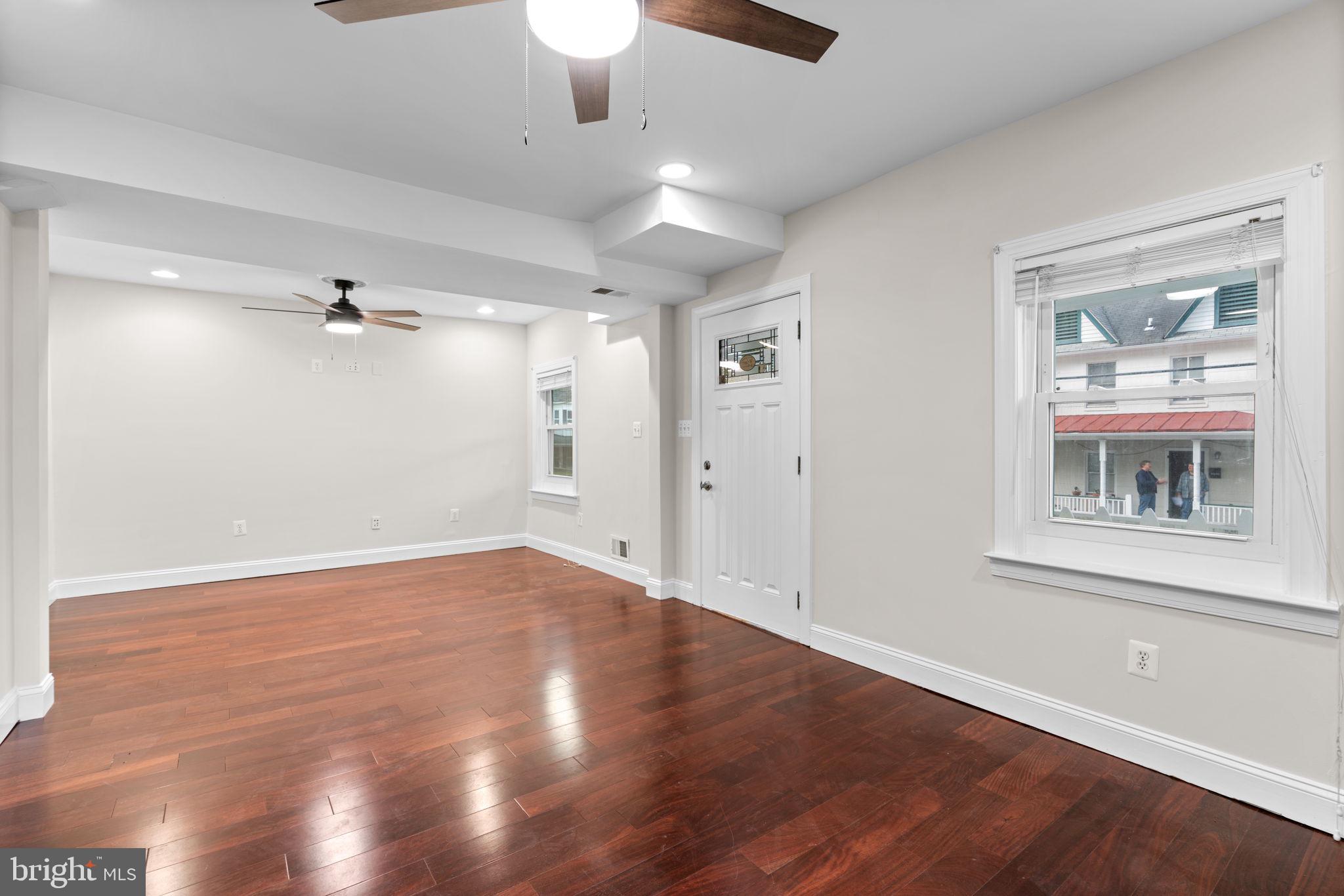 8483 Frederick Road Ellicott City, MD 21043 - Photo 7 of 44 wooden floor in an empty room with a window