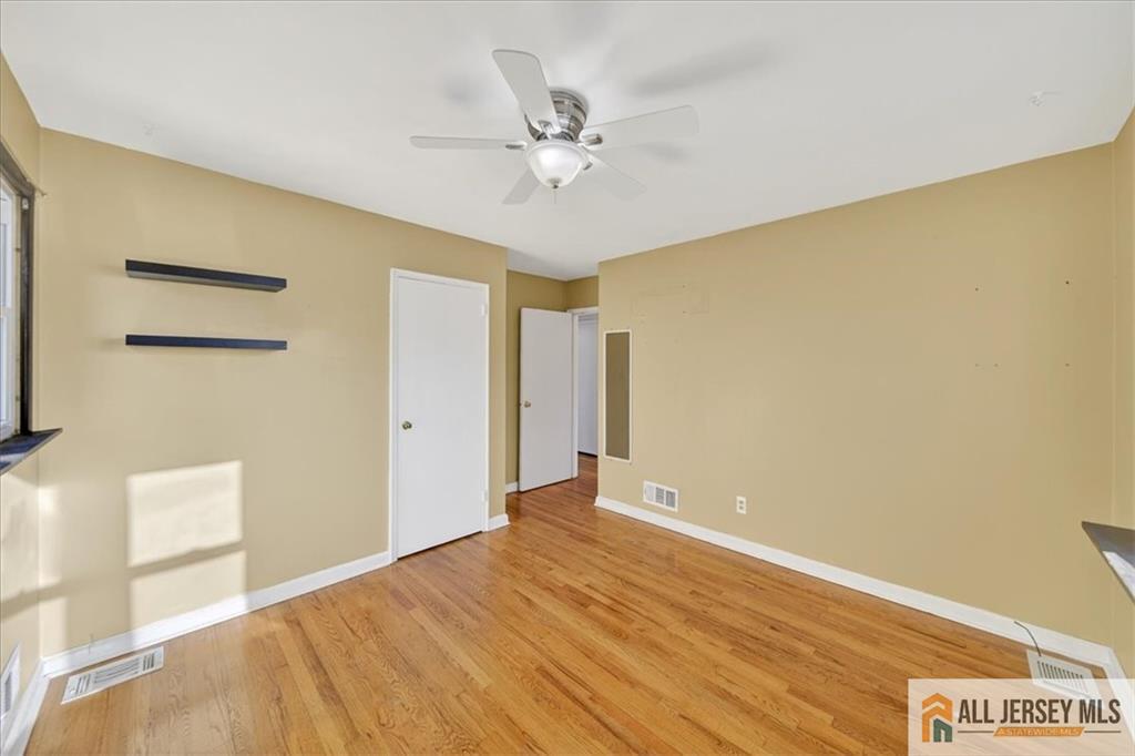 6 Dundar Road Edison, NJ 08817 - Photo 15 of 22 a view of a room with wooden floor and a ceiling fan