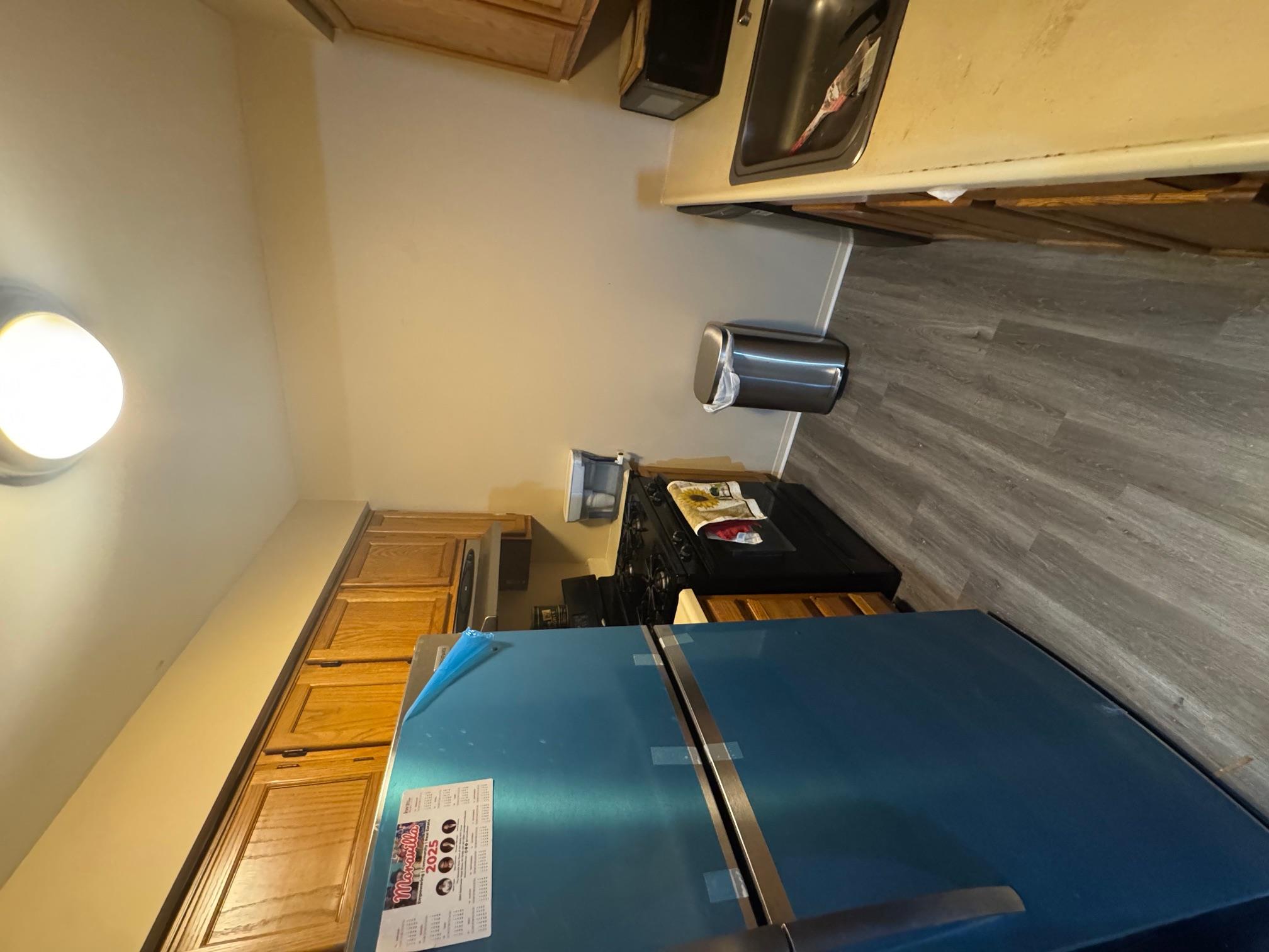 1987 Prospect Avenue Bronx, NY 10457 - Photo 4 of 13 a kitchen with stainless steel appliances granite countertop a refrigerator a stove and a sink with wooden floor