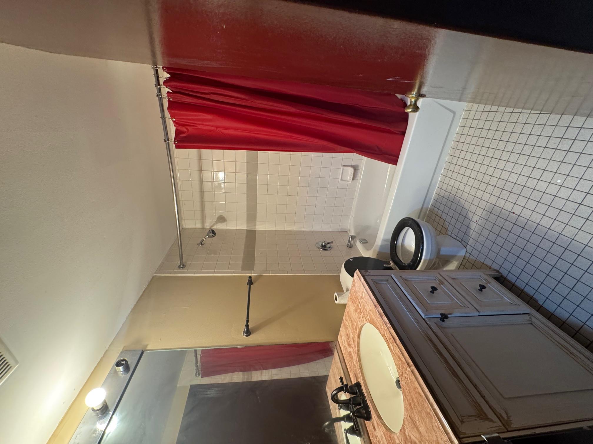 1987 Prospect Avenue Bronx, NY 10457 - Photo 7 of 13 a bathroom with a sink a toilet a mirror and shower