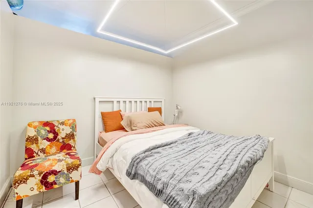 a bedroom with a bed and a view of kitchen