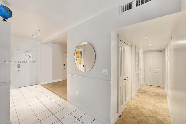 a bathroom with a granite countertop sink a mirror and shower
