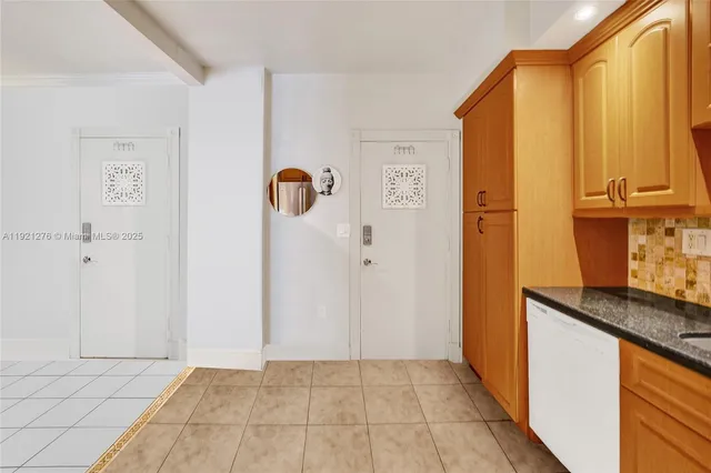 a kitchen with stainless steel appliances granite countertop a refrigerator and a stove