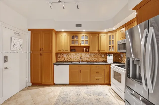 a kitchen with stainless steel appliances a refrigerator and stove