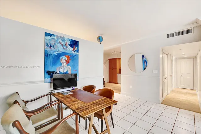 a living room with furniture a rug and a table