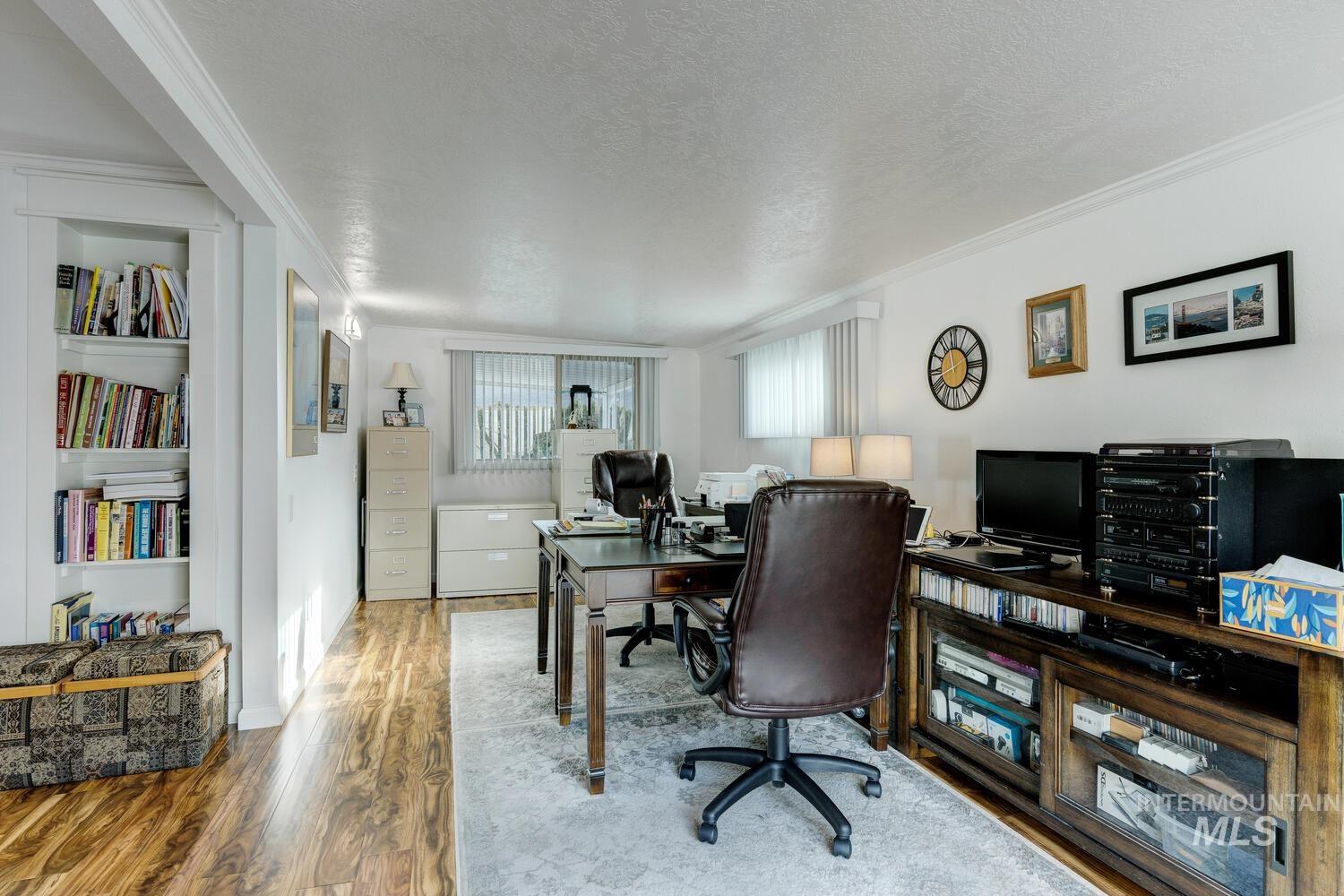 9390 West Ustick Road, Unit 64 Boise, ID 83704 - Photo 19 of 36 Home office with a textured ceiling, wood finished floors, and crown molding