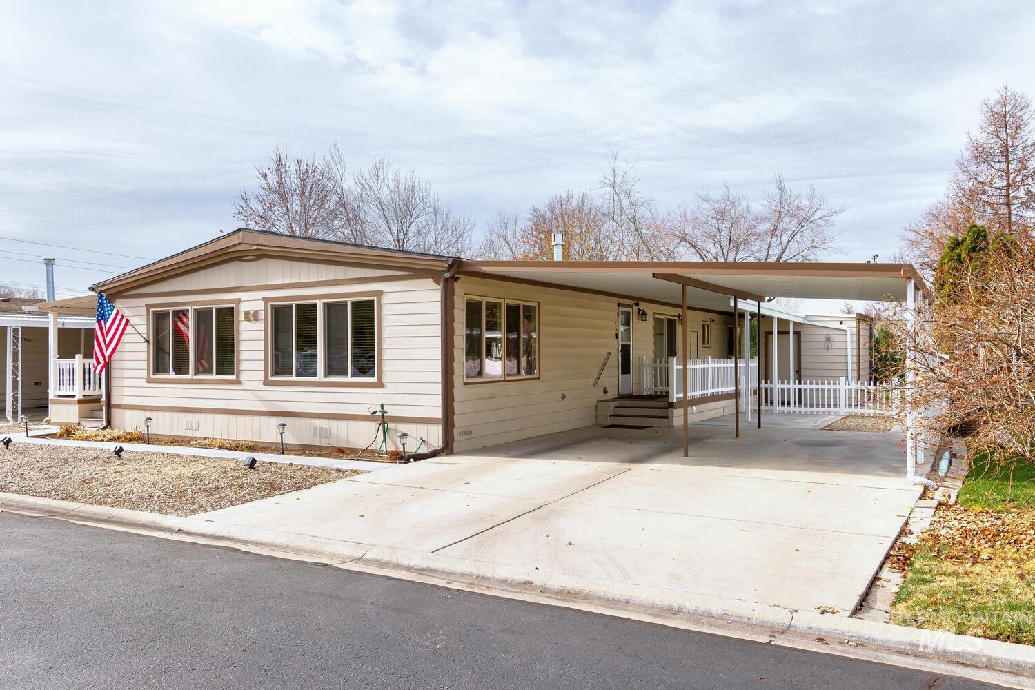 9390 West Ustick Road, Unit 64 Boise, ID 83704 - Photo 3 of 36 Manufactured / mobile home featuring a carport, concrete driveway, and a porch