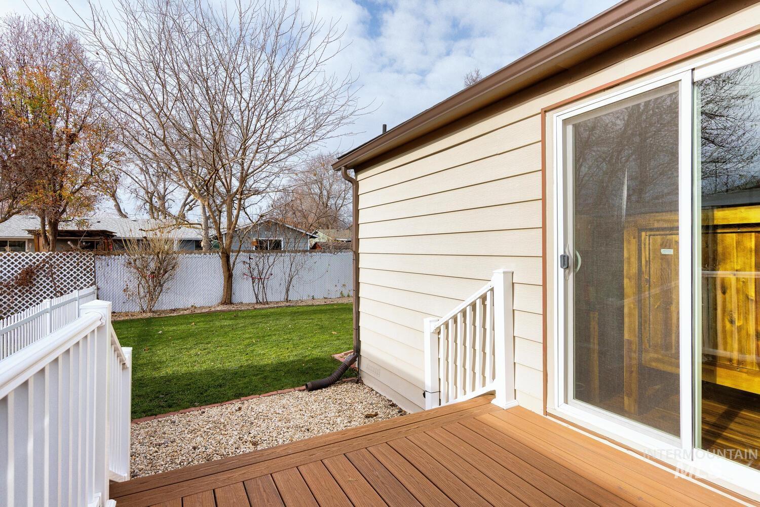 9390 West Ustick Road, Unit 64 Boise, ID 83704 - Photo 31 of 36 Wooden terrace featuring a fenced backyard