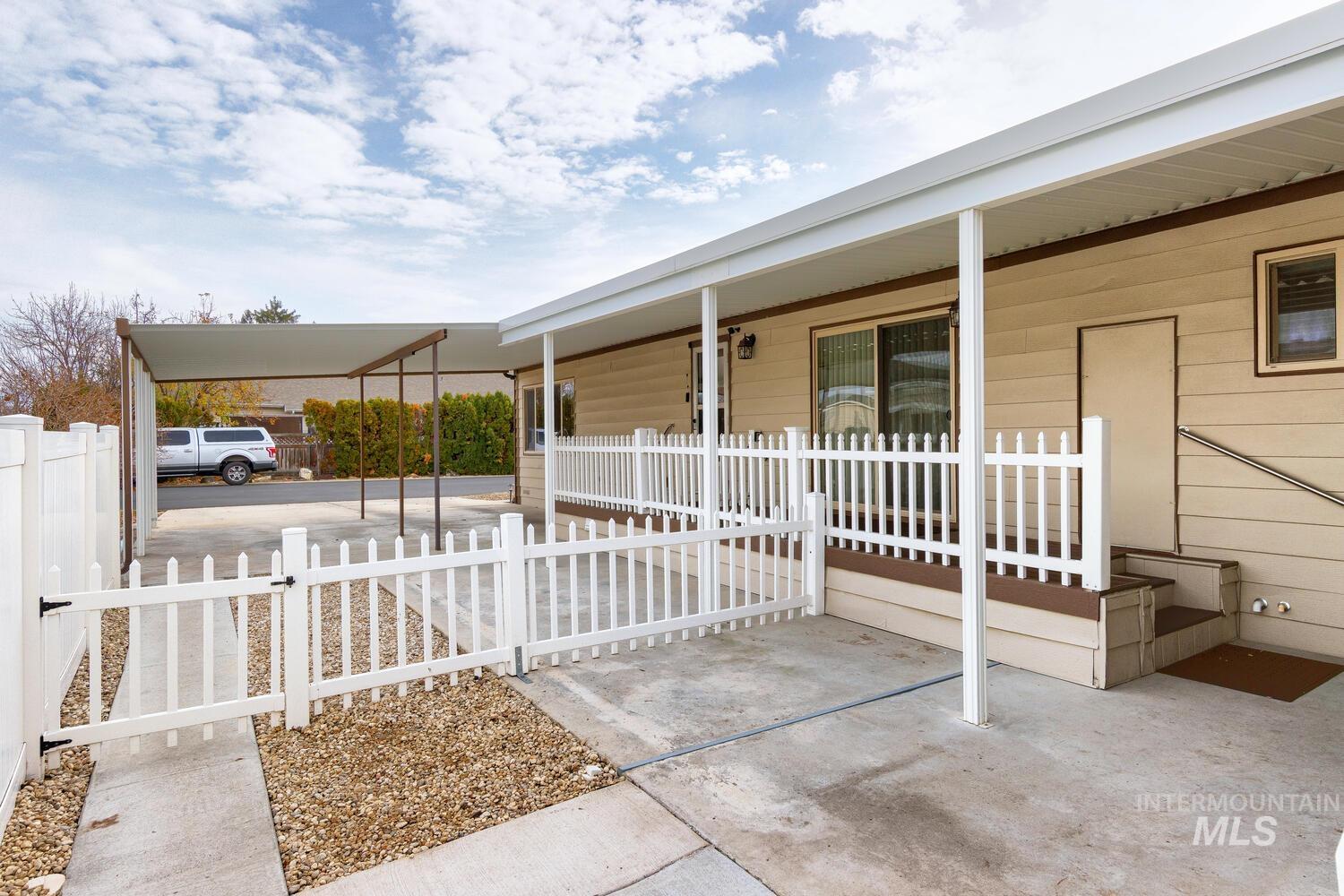 9390 West Ustick Road, Unit 64 Boise, ID 83704 - Photo 35 of 36 Porch featuring a gate and a carport