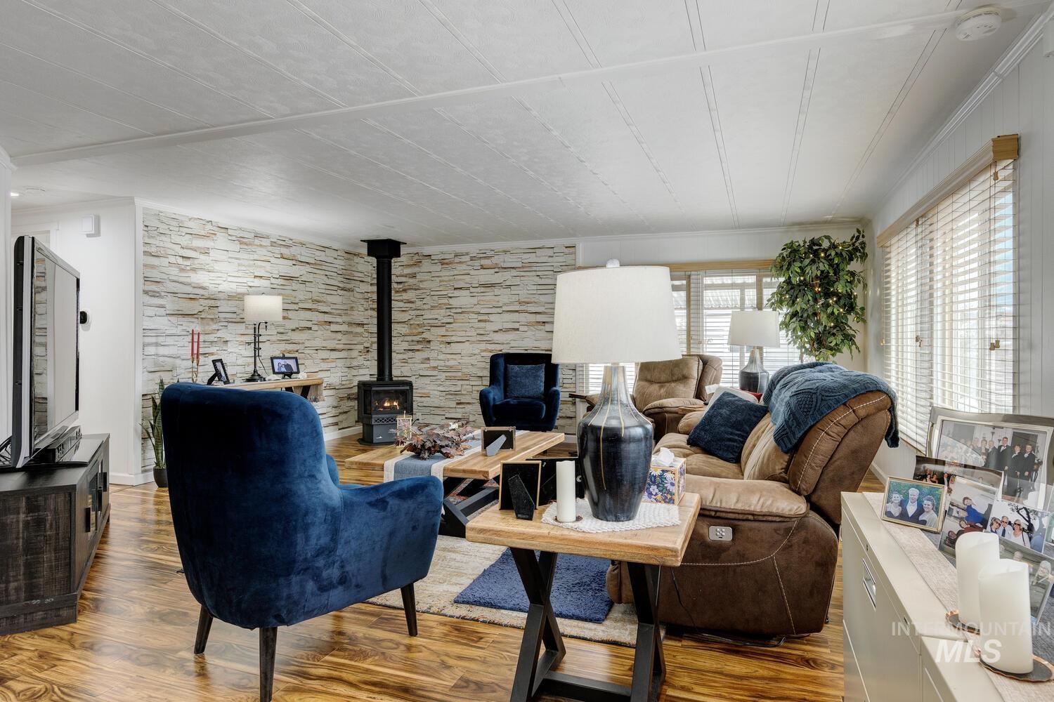 9390 West Ustick Road, Unit 64 Boise, ID 83704 - Photo 6 of 36 Living room featuring a wood stove and wood finished floors