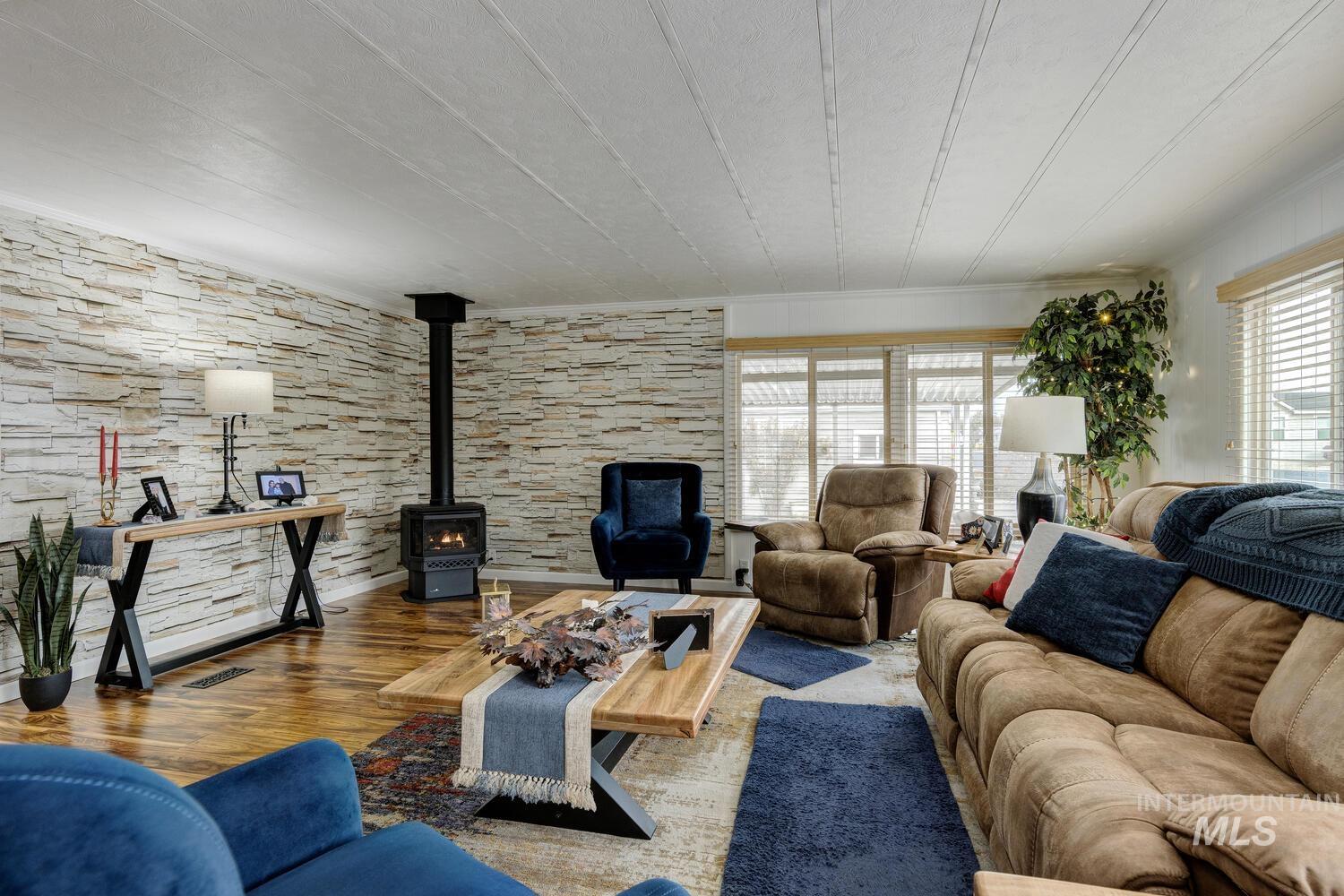 9390 West Ustick Road, Unit 64 Boise, ID 83704 - Photo 7 of 36 Living room with a wood stove and wood finished floors